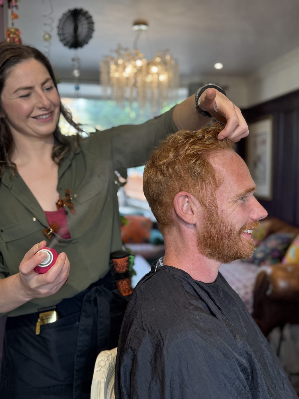 Charlotte Parker cutting a client&rsquo;s hair in his own living room